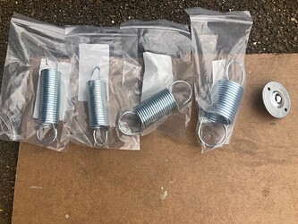 Four different springs and a ball bearing castor.